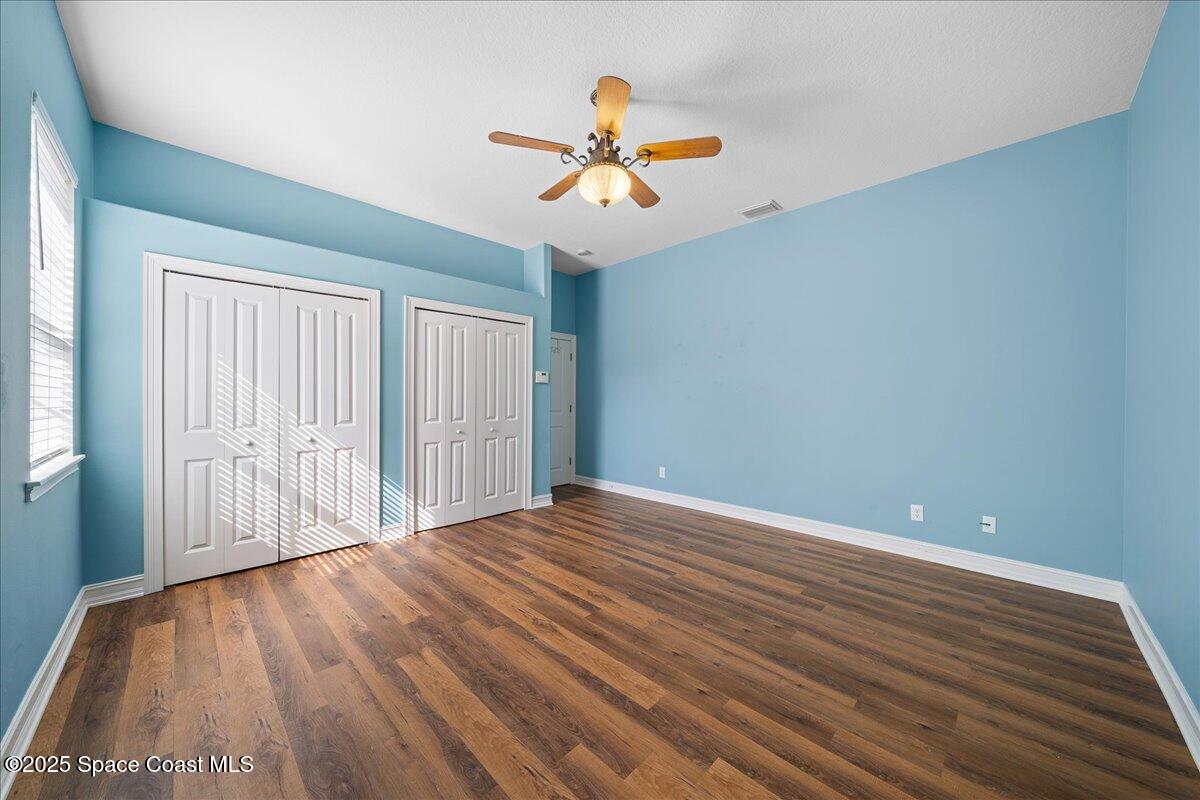 7831 Winona Road Melbourne Beach, FL 32951 - Photo 9 of 41 wooden floor in an empty room with a window