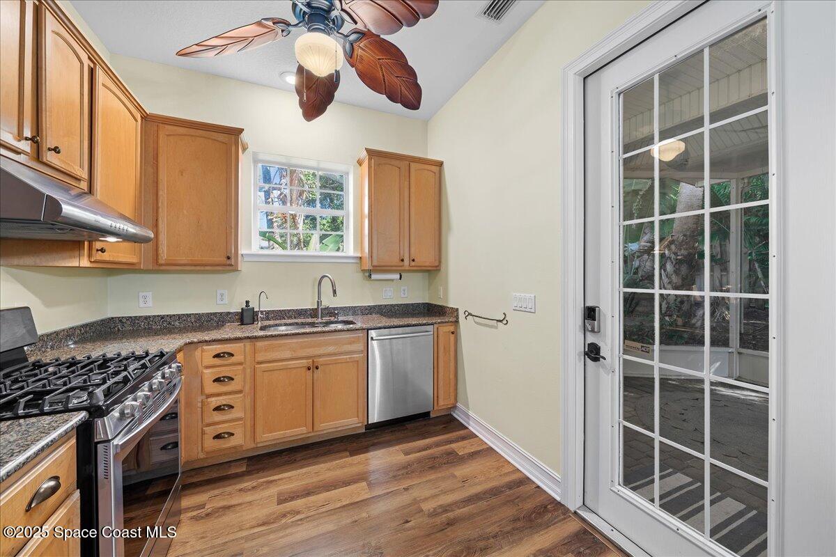 7831 Winona Road Melbourne Beach, FL 32951 - Photo 10 of 41 a kitchen with stainless steel appliances granite countertop a stove and a sink