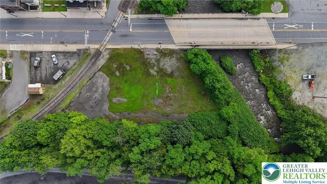 a view of a backyard with couches under an umbrella