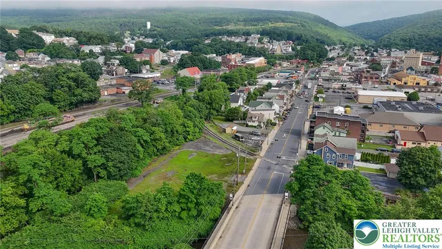 an aerial view of residential houses with outdoor space and river