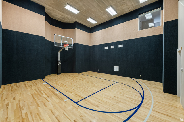 1205 North Elk Rdg Lane, Unit 202 Alpine, UT 84004 - Photo 51 of 88 Indoor gymnasium featuring a full basketball court with wood-finish flooring, a mounted basketball hoop, and padded wall surfaces