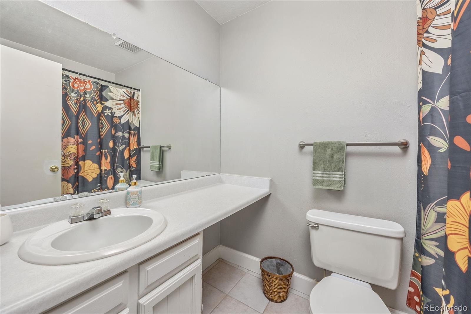 8782 Carr Loop Arvada, CO 80005 - Photo 13 of 23 a bathroom with a sink toilet and a mirror