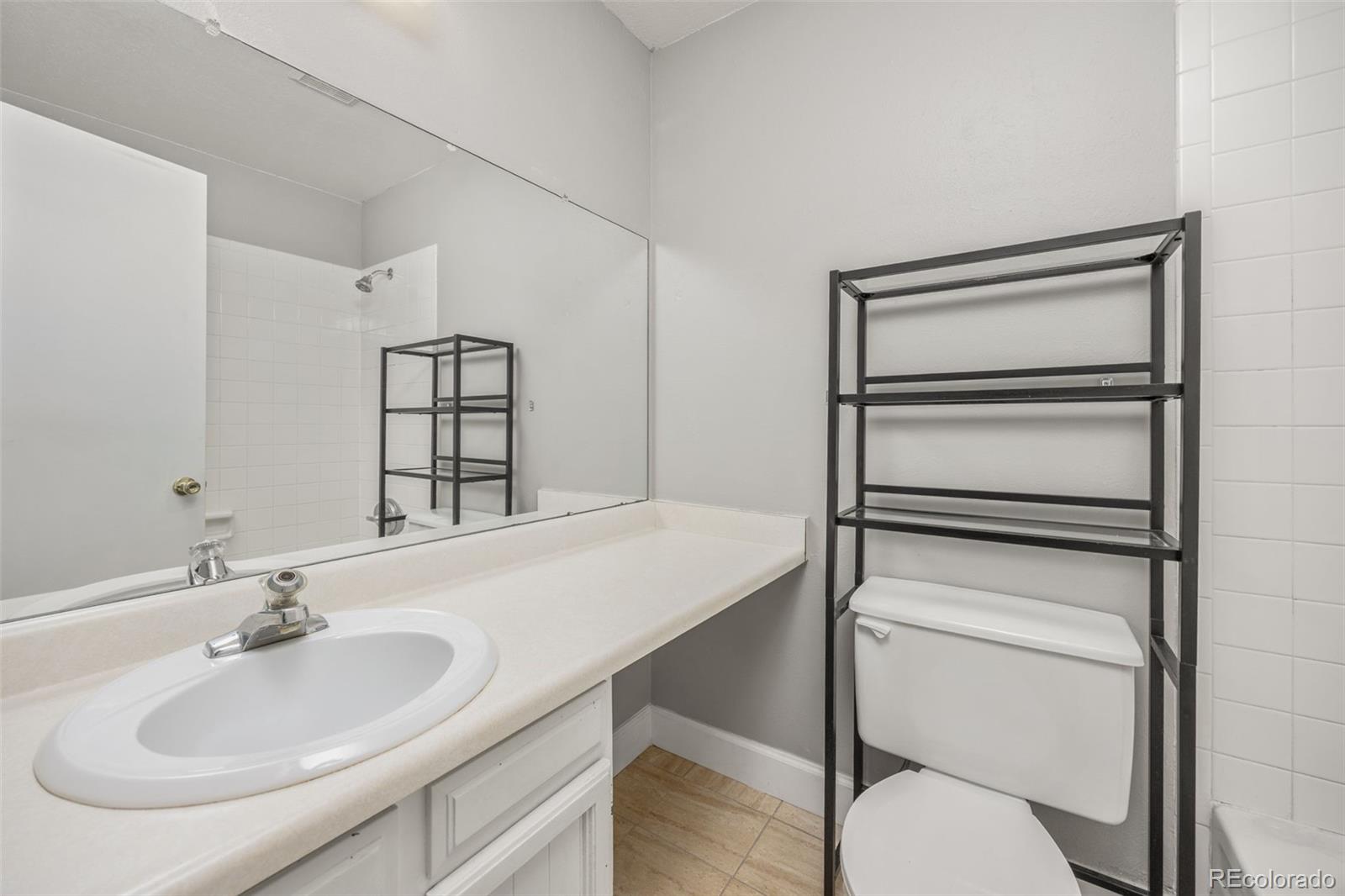 8782 Carr Loop Arvada, CO 80005 - Photo 15 of 23 a bathroom with a sink toilet vanity and tub