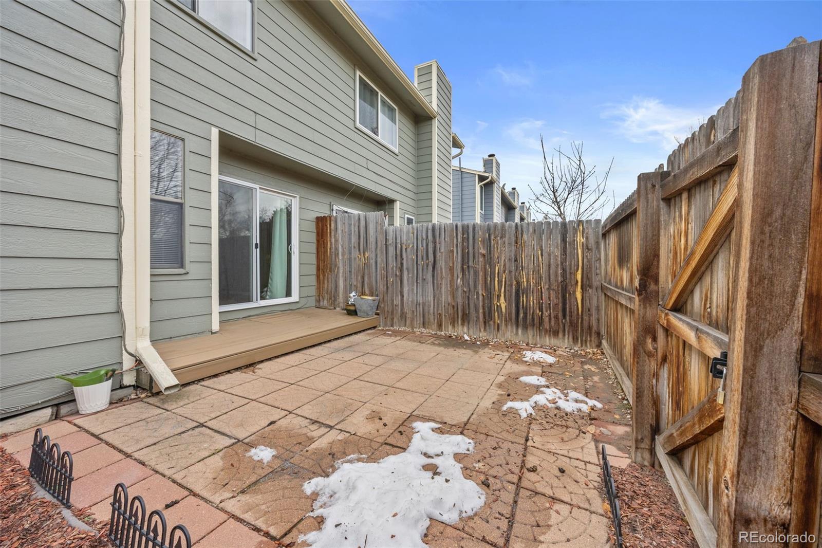 8782 Carr Loop Arvada, CO 80005 - Photo 19 of 23 a view of house with backyard and wooden fence