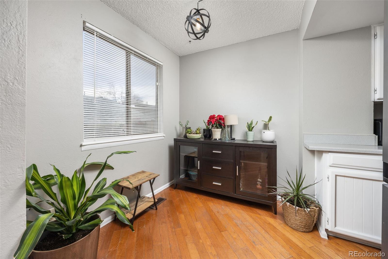 8782 Carr Loop Arvada, CO 80005 - Photo 4 of 23 a dining room with furniture and a potted plant