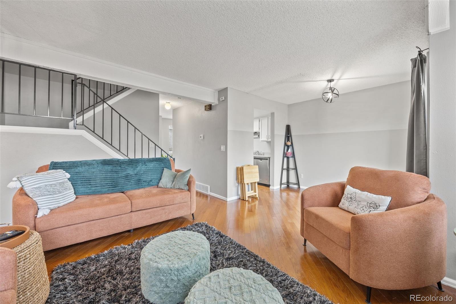 8782 Carr Loop Arvada, CO 80005 - Photo 8 of 23 a living room with furniture and a wooden floor