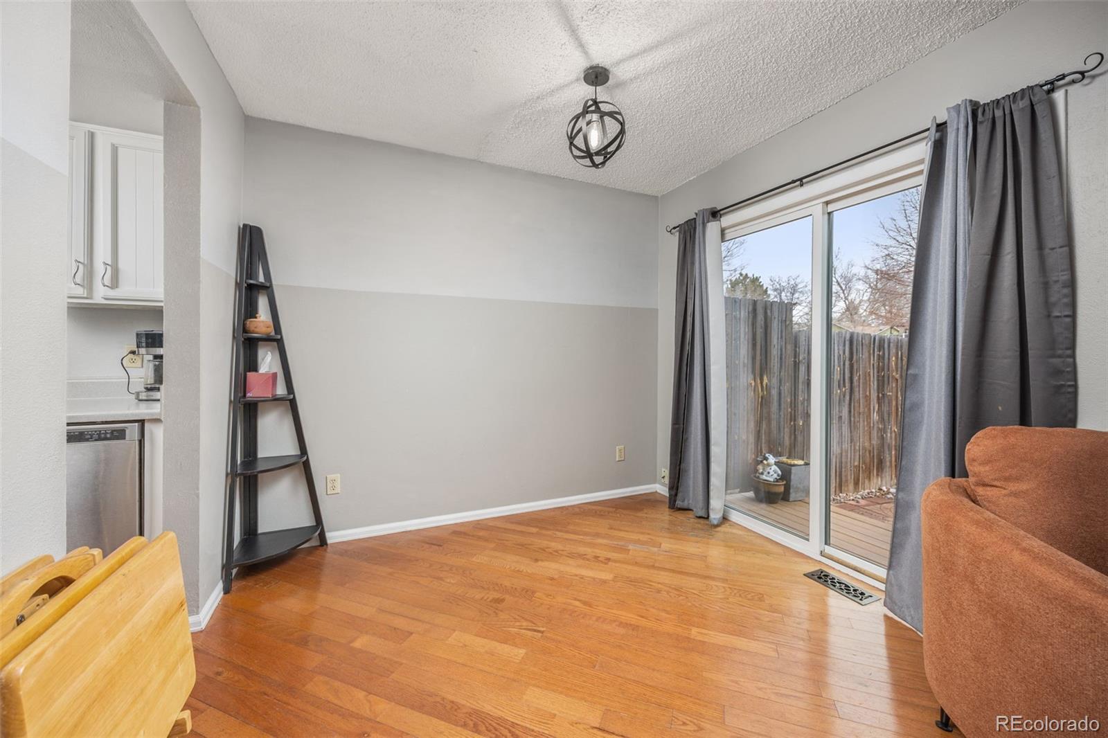 8782 Carr Loop Arvada, CO 80005 - Photo 9 of 23 a view of empty room with wooden floor and fan