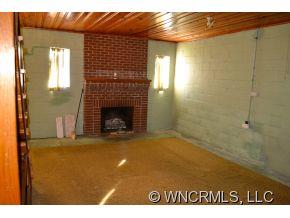 2868 Max Patch Road Clyde, NC 28721 - Photo 14 of 19 a view of empty room with window and fireplace