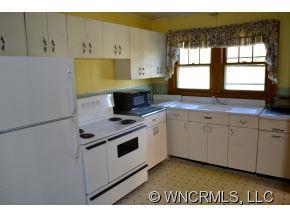 2868 Max Patch Road Clyde, NC 28721 - Photo 7 of 19 a kitchen with a sink a stove and cabinets