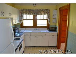 2868 Max Patch Road Clyde, NC 28721 - Photo 8 of 19 a kitchen with granite countertop a sink cabinets and a window
