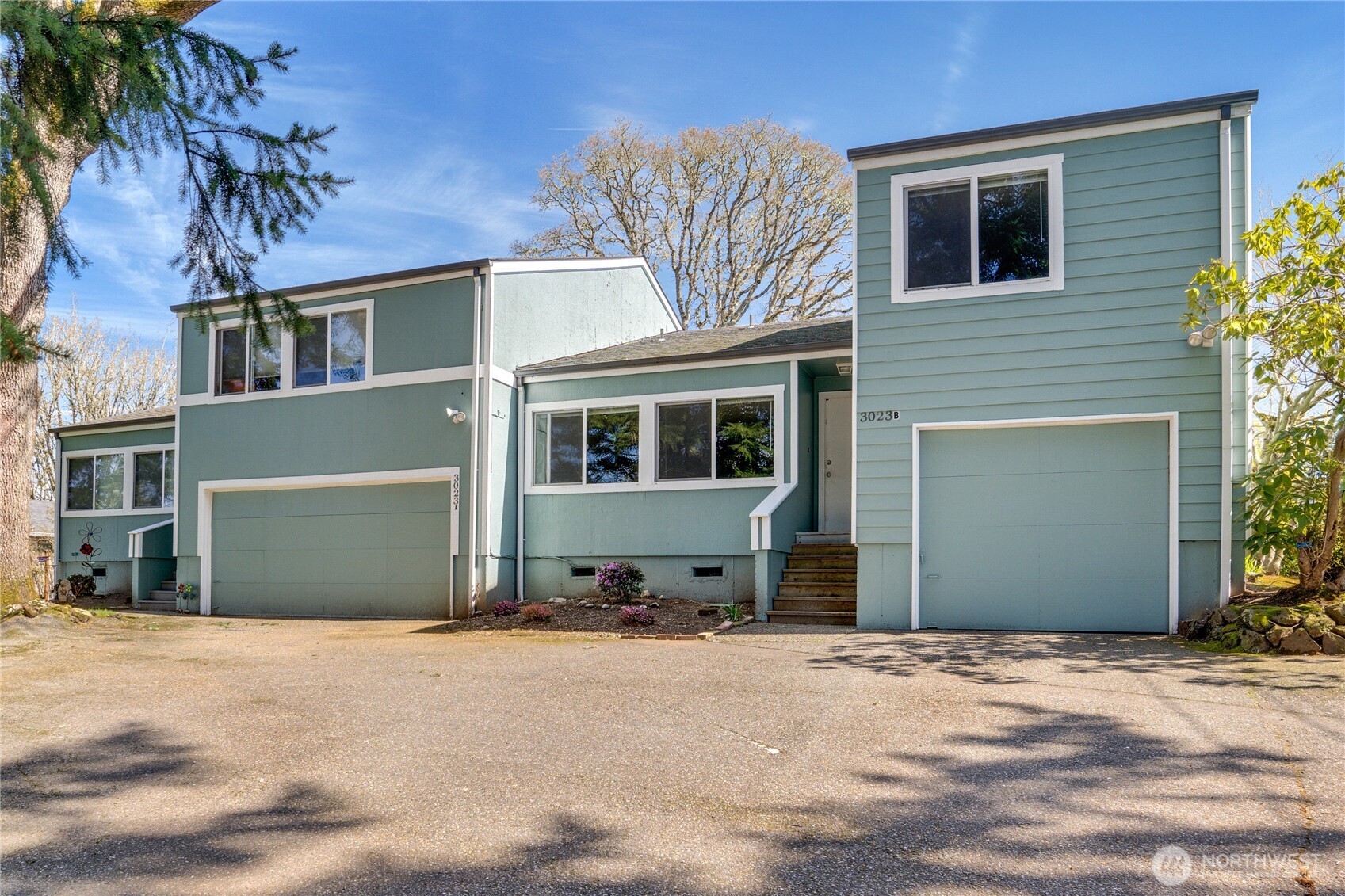 3023 Bridgeport Way West, Unit B University Place, WA 98466 - Photo 1 of 30 a front view of a house with a yard