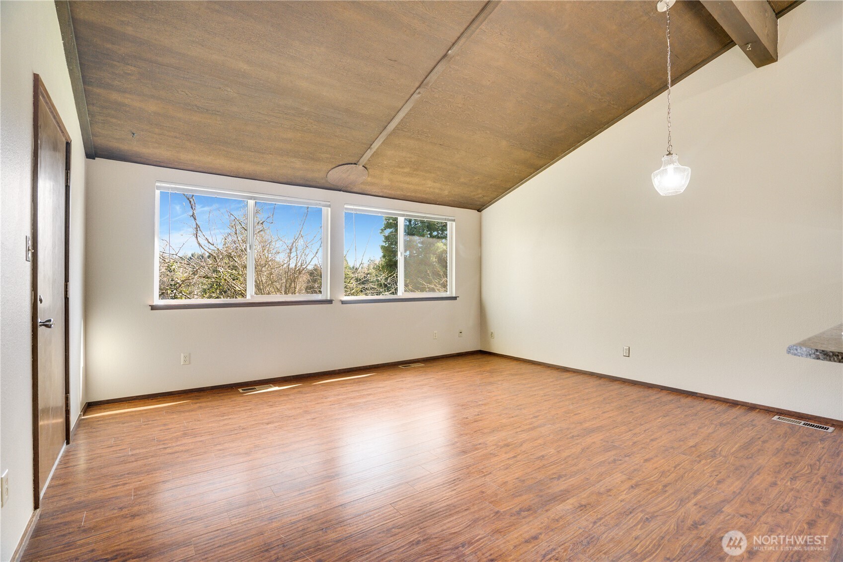 3023 Bridgeport Way West, Unit B University Place, WA 98466 - Photo 12 of 30 an empty room with wooden floor and windows