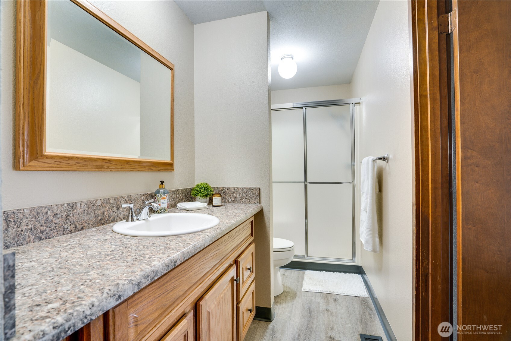 3023 Bridgeport Way West, Unit B University Place, WA 98466 - Photo 14 of 30 a bathroom with a granite countertop sink and a mirror