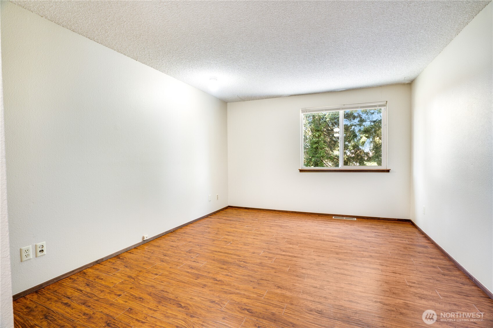 3023 Bridgeport Way West, Unit B University Place, WA 98466 - Photo 17 of 30 an empty room with wooden floor and window