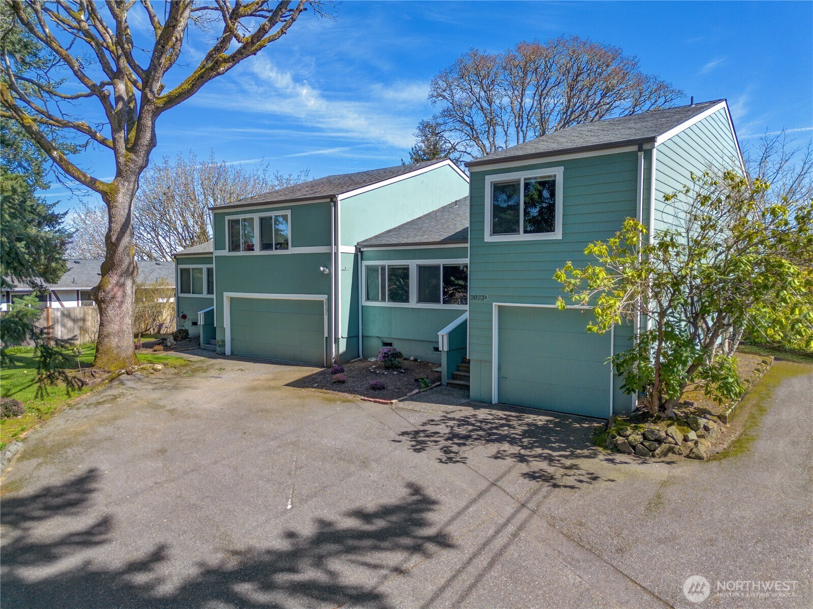 3023 Bridgeport Way West, Unit B University Place, WA 98466 - Photo 2 of 30 a front view of a house with a garden