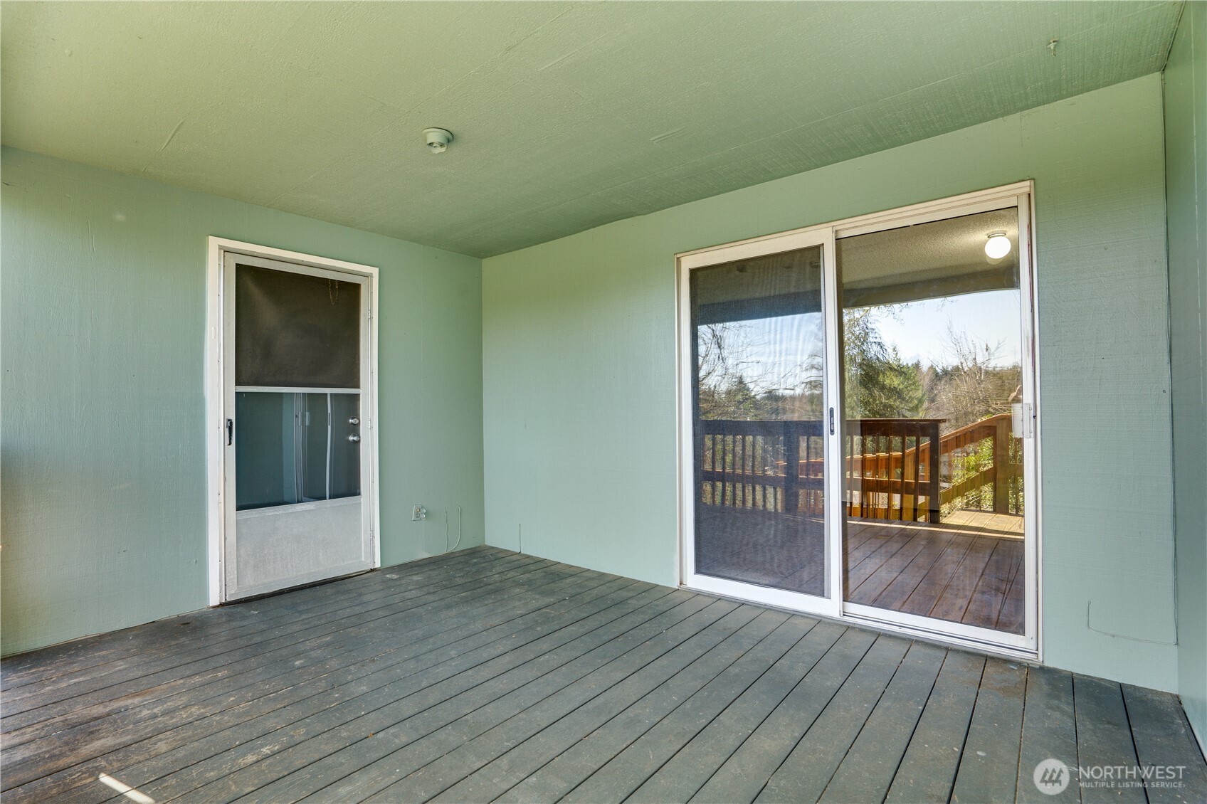 3023 Bridgeport Way West, Unit B University Place, WA 98466 - Photo 21 of 30 an empty room with wooden floor and windows
