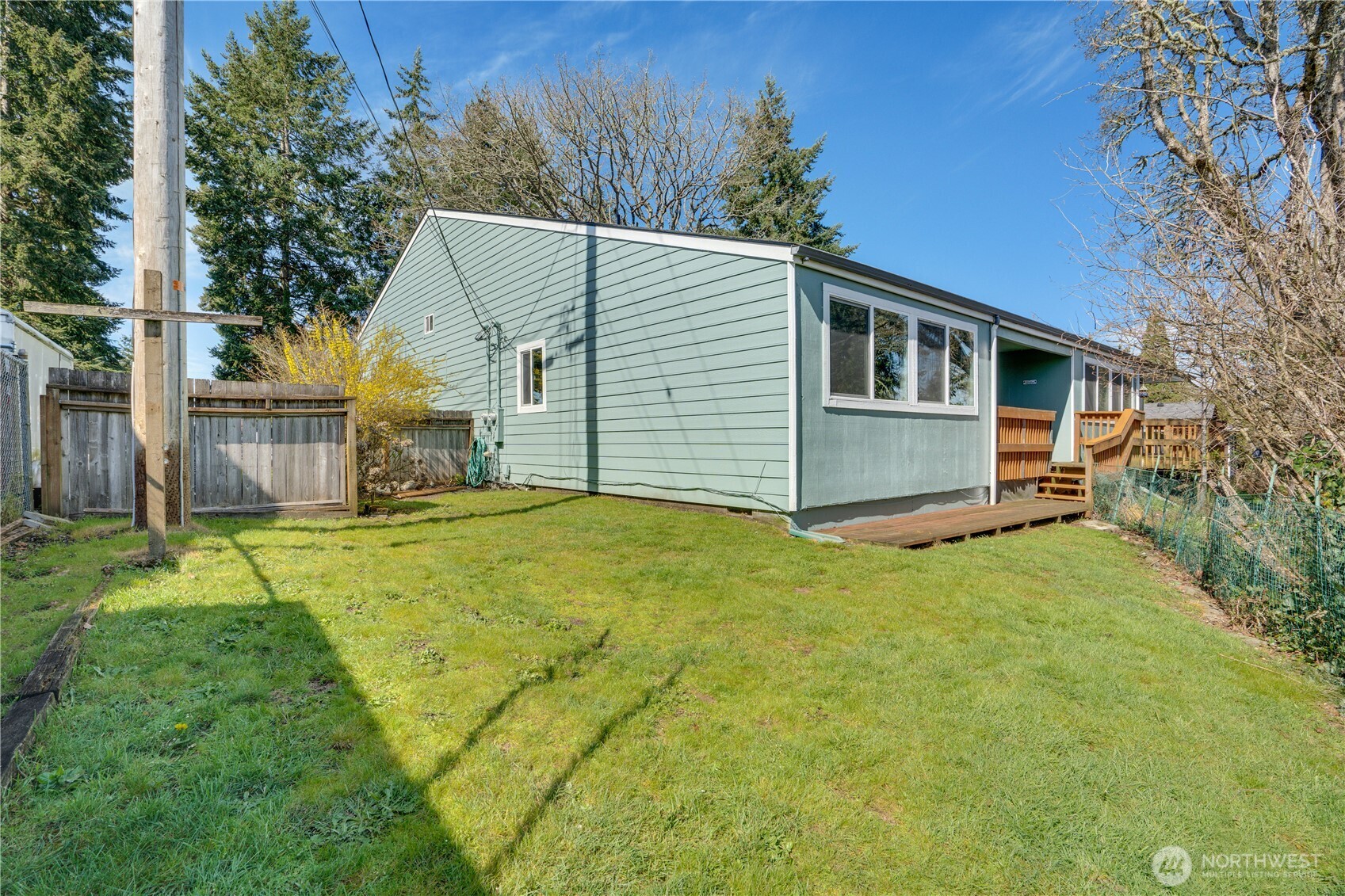 3023 Bridgeport Way West, Unit B University Place, WA 98466 - Photo 24 of 30 a house with trees in front of it