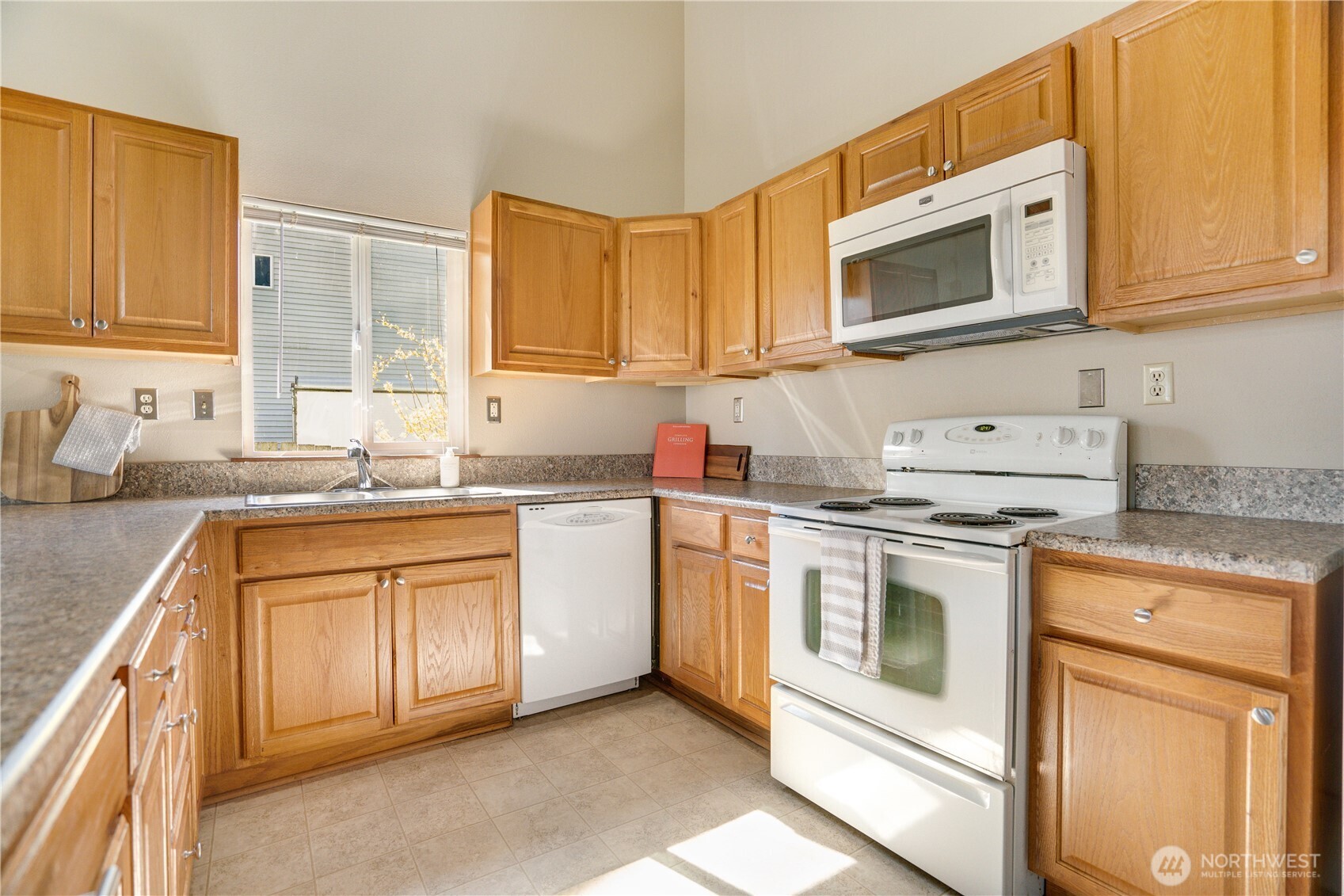 3023 Bridgeport Way West, Unit B University Place, WA 98466 - Photo 4 of 30 a kitchen with stainless steel appliances granite countertop grey cabinets sink and stove