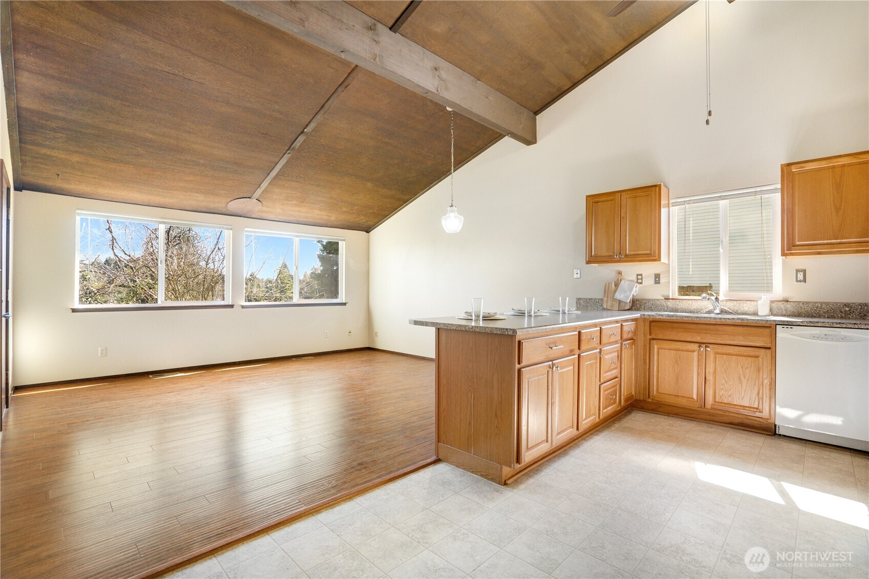 3023 Bridgeport Way West, Unit B University Place, WA 98466 - Photo 7 of 30 a large kitchen with stainless steel appliances granite countertop a stove a sink and a microwave
