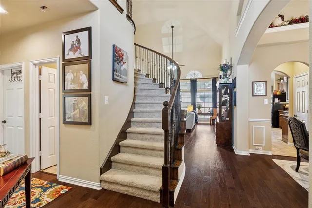a view of entryway and hall with wooden floor
