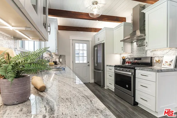 a kitchen with sink and refrigerator