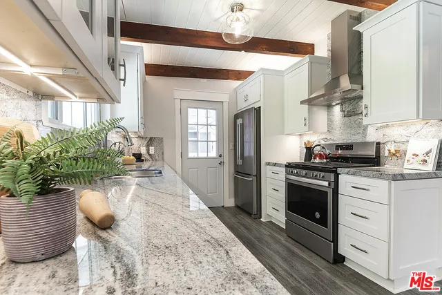 a kitchen with sink and refrigerator