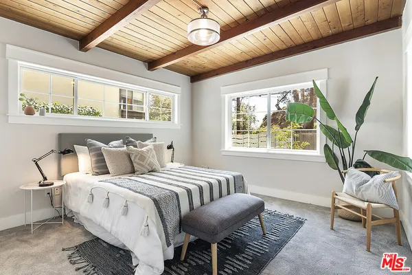 a bedroom with bed and a window