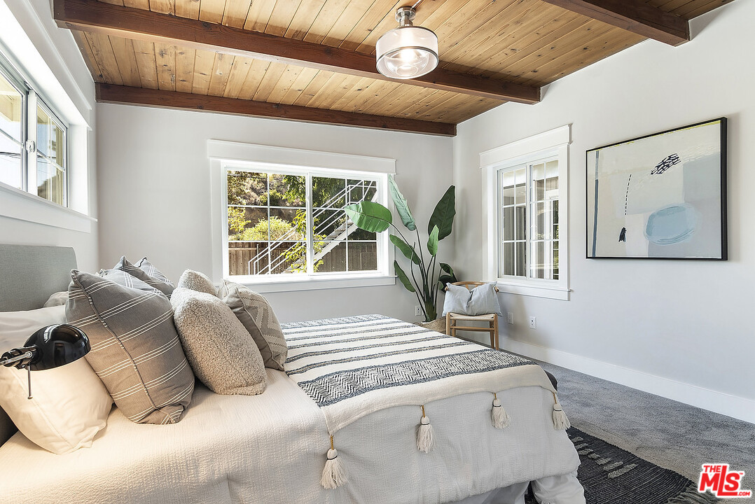3908-a Las Flores Canyon Road Malibu, CA 90265 - Photo 25 of 60 a bed sitting in a bedroom next to a window