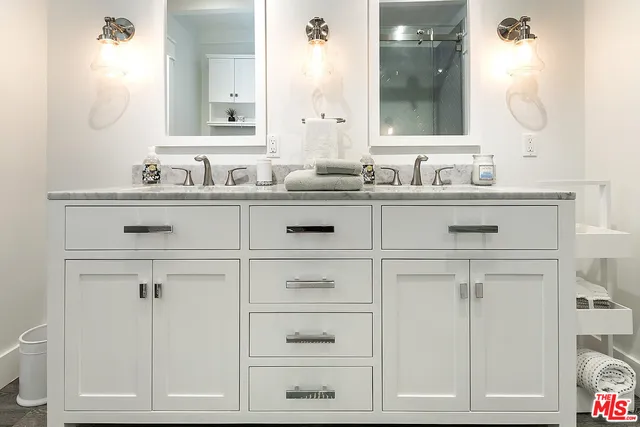 a bathroom with a sink vanity and mirror