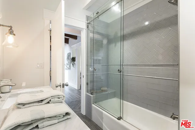 a bathroom with a shower and a sink