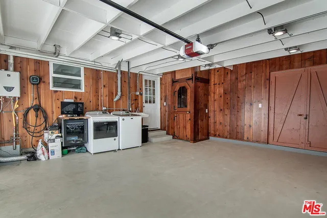 a view of a balcony with chairs and wooden floor