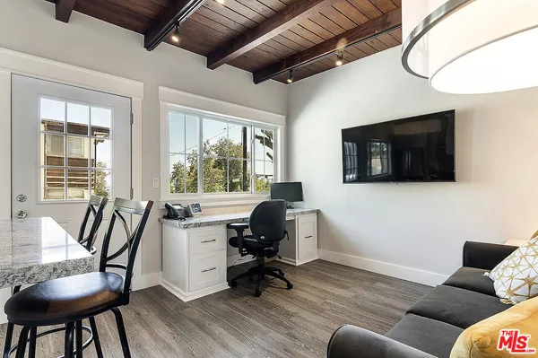 a kitchen with granite countertop a refrigerator stove and sink
