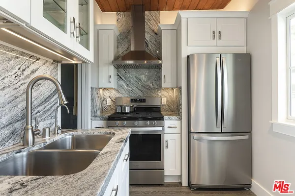 a bathroom with a sink vanity and shower