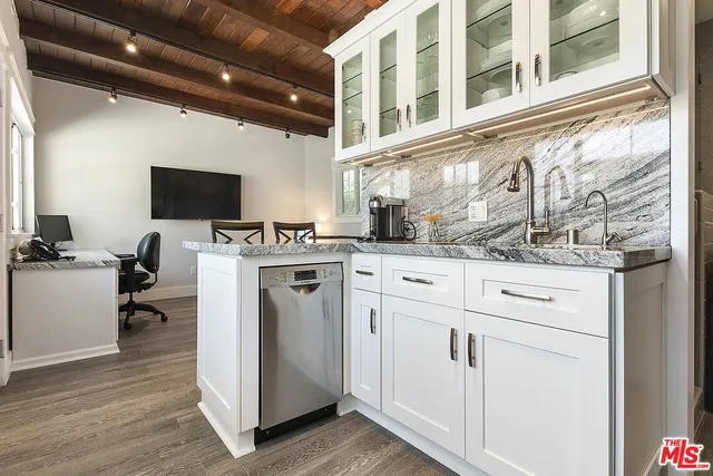 a view of patio with chairs and table under an umbrella