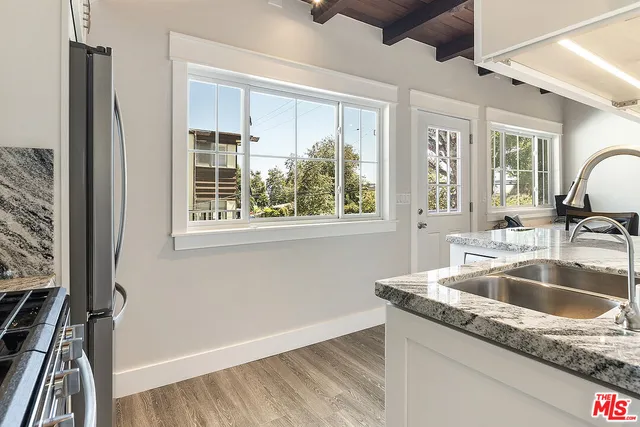 a view of a patio with furniture under an umbrella