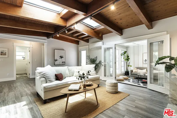 a living room with furniture and wooden floor