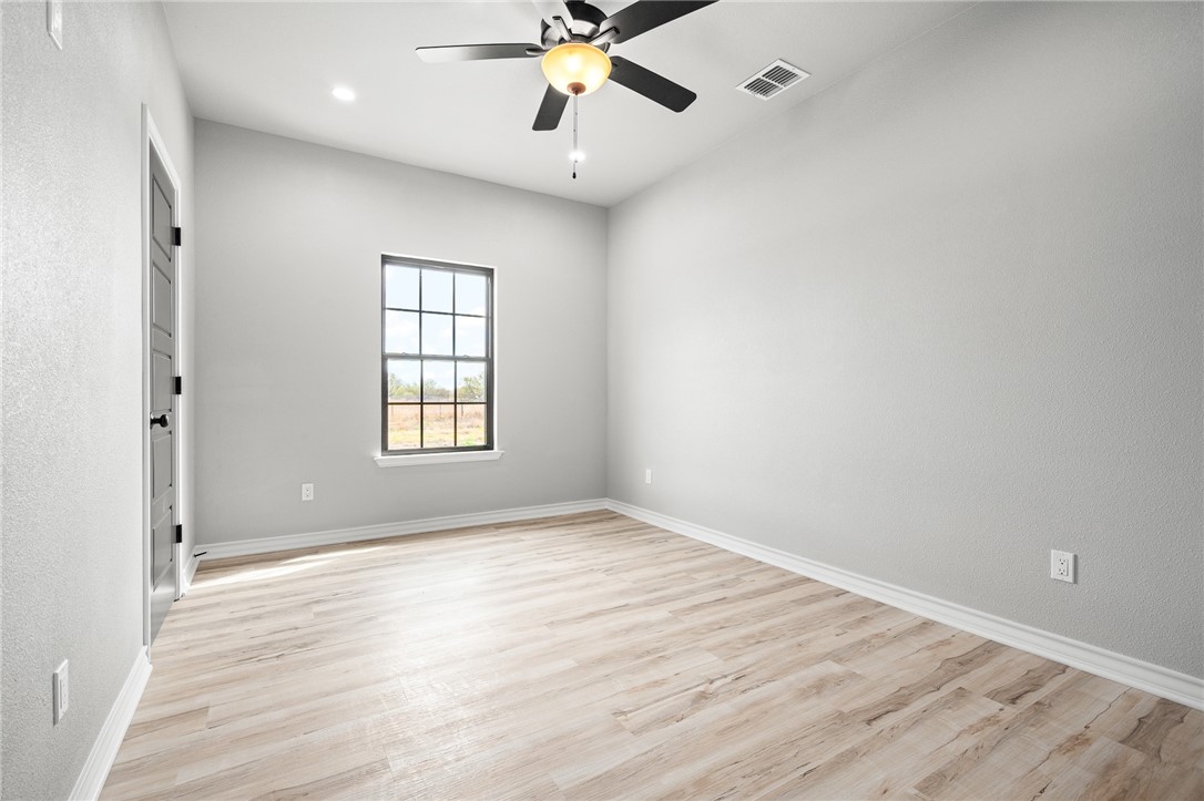 12706 County Road 1394 Sinton, TX 78387 - Photo 25 of 38 wooden floor in an empty room with a window