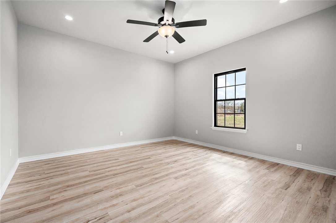 12706 County Road 1394 Sinton, TX 78387 - Photo 26 of 38 wooden floor in an empty room with a window