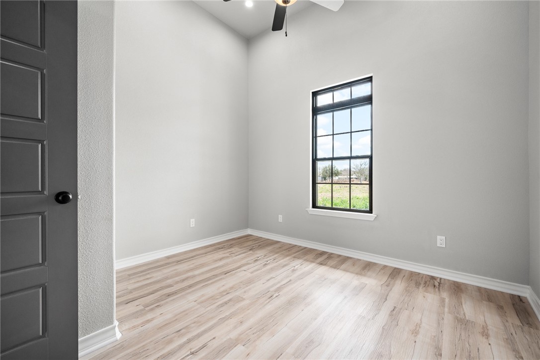 12706 County Road 1394 Sinton, TX 78387 - Photo 30 of 38 a view of empty room with wooden floor and fan
