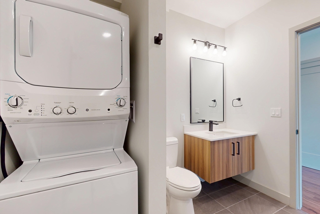 80 Rugg Road, Unit 1227 Boston, MA 02134 - Photo 11 of 13 a bathroom with a toilet sink and mirror