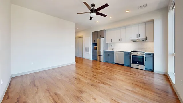 a view of kitchen with wooden floor and a window