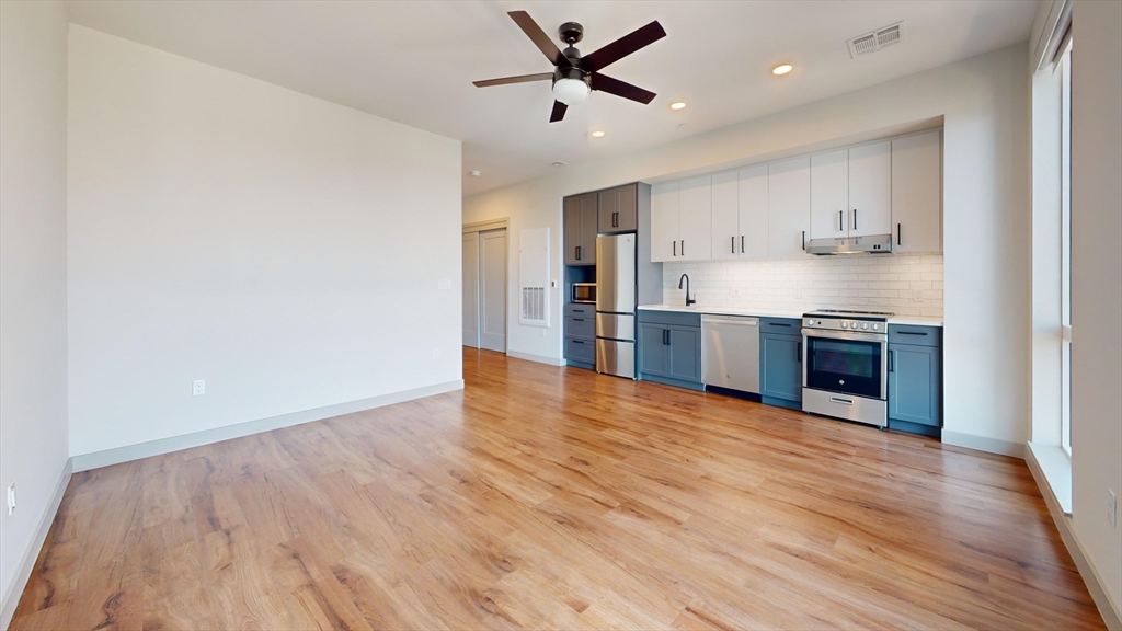 80 Rugg Road, Unit 1227 Boston, MA 02134 - Photo 2 of 13 a view of kitchen with wooden floor and a window
