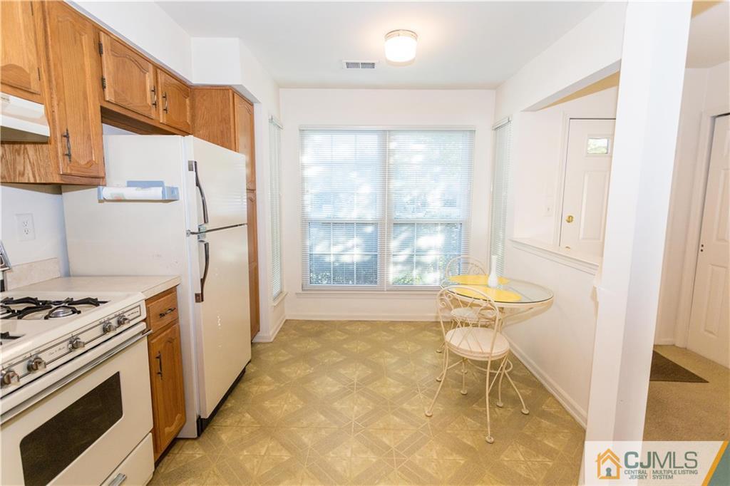 405 Maplecrest Road, Unit 405 Edison, NJ 08820 - Photo 11 of 33 a kitchen with stainless steel appliances a stove a refrigerator and cabinets