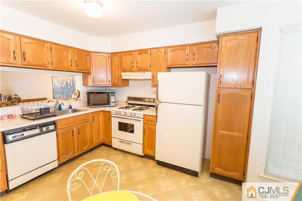 405 Maplecrest Road, Unit 405 Edison, NJ 08820 - Photo 12 of 33 a kitchen with a refrigerator sink stove and cabinets
