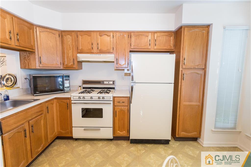 405 Maplecrest Road, Unit 405 Edison, NJ 08820 - Photo 13 of 33 a white refrigerator freezer sitting inside of a kitchen