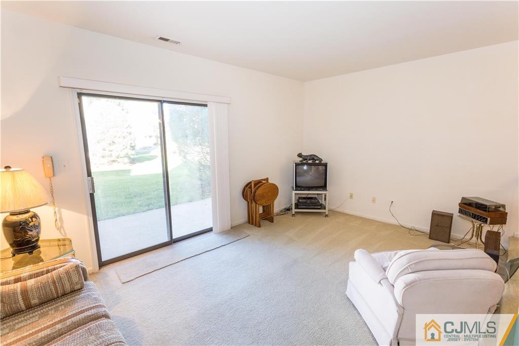 405 Maplecrest Road, Unit 405 Edison, NJ 08820 - Photo 15 of 33 a bedroom with furniture and a large window