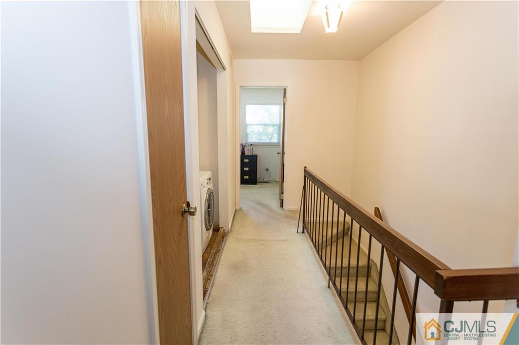 405 Maplecrest Road, Unit 405 Edison, NJ 08820 - Photo 17 of 33 a view of a hallway with wooden floor and staircase