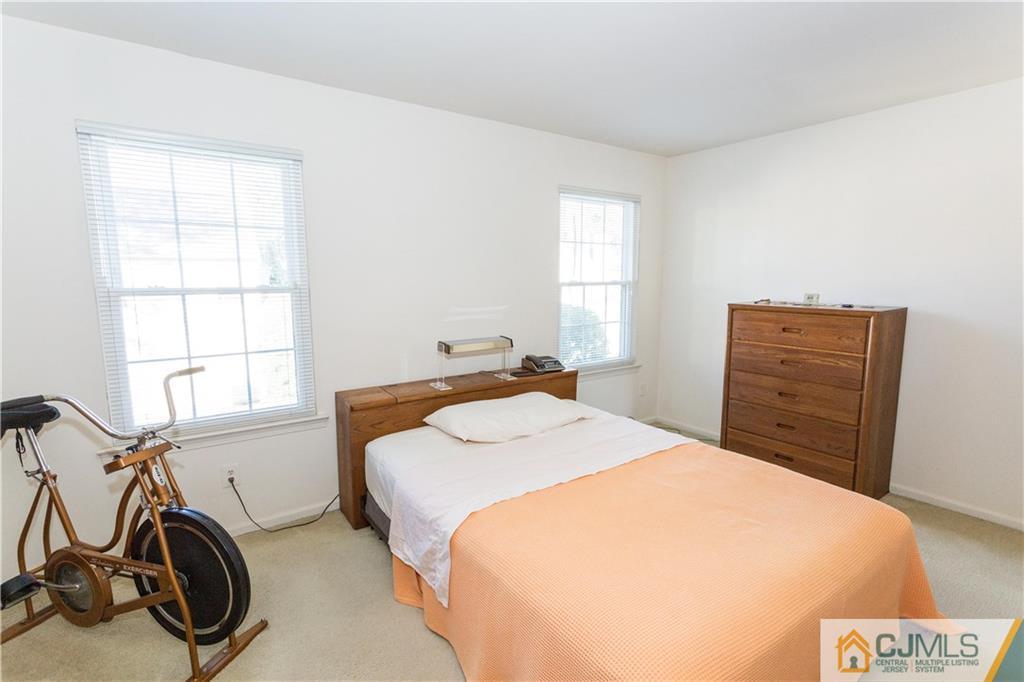 405 Maplecrest Road, Unit 405 Edison, NJ 08820 - Photo 18 of 33 a bed room with a bed and a window