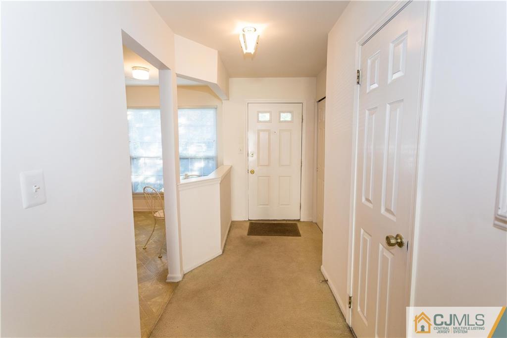 405 Maplecrest Road, Unit 405 Edison, NJ 08820 - Photo 3 of 33 a view of a hallway with wooden floor and closet area