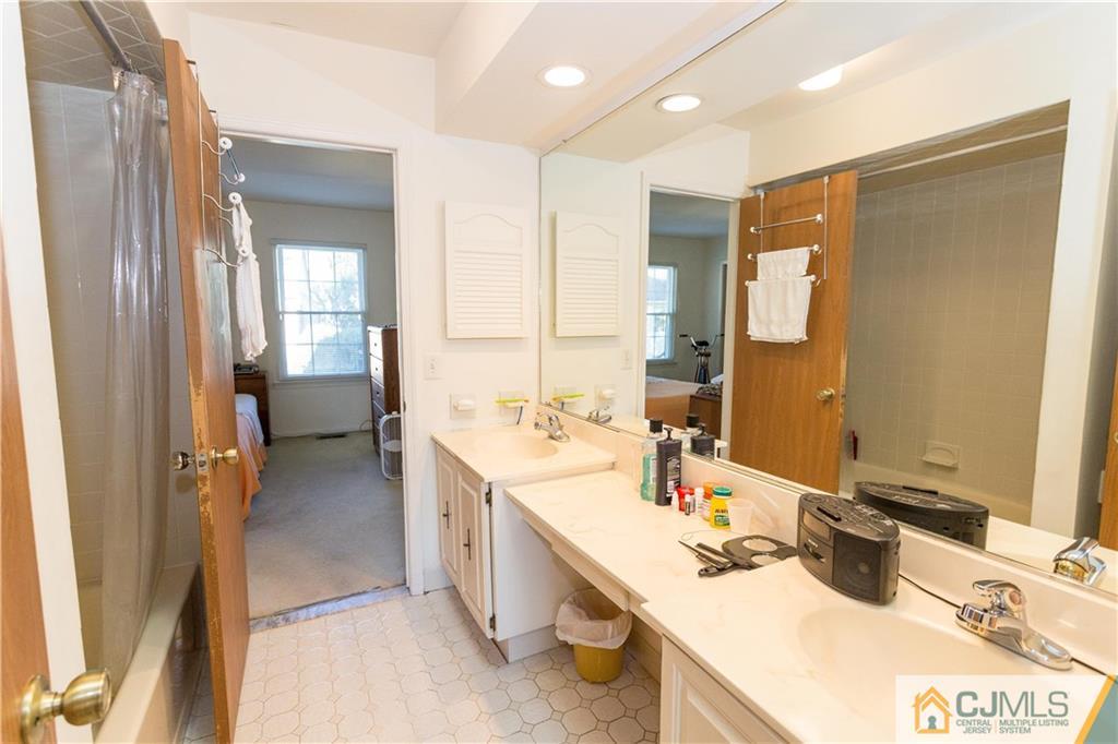 405 Maplecrest Road, Unit 405 Edison, NJ 08820 - Photo 21 of 33 a bathroom with a sink double vanity and a mirror